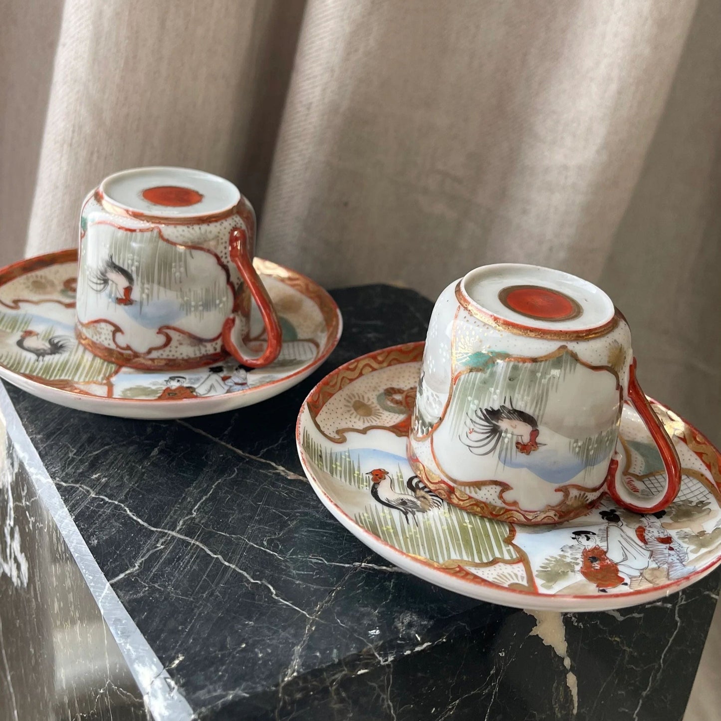 A Pair of Red Japanese Espresso Cups and Saucers