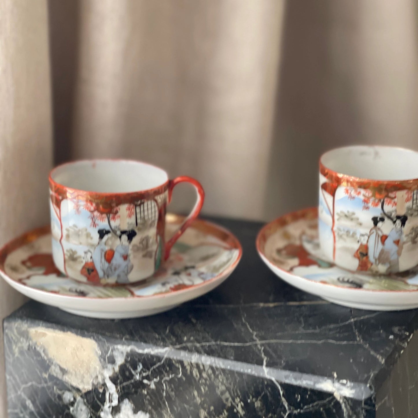 A Pair of Red Japanese Espresso Cups and Saucers