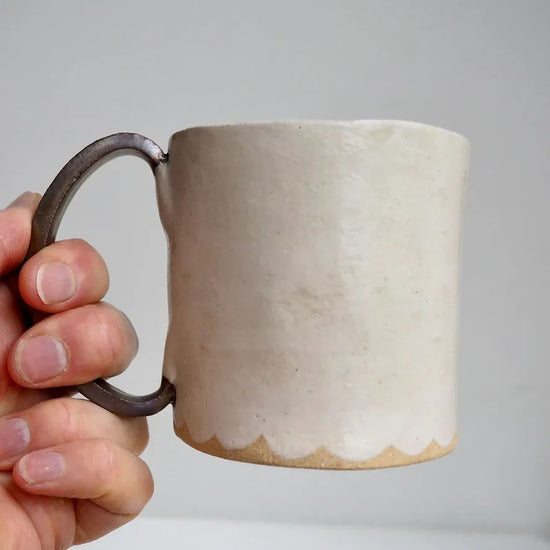 Cream ceramic muCream Ceramic Mug with a Scalloped Lower Edge and Gold Handle