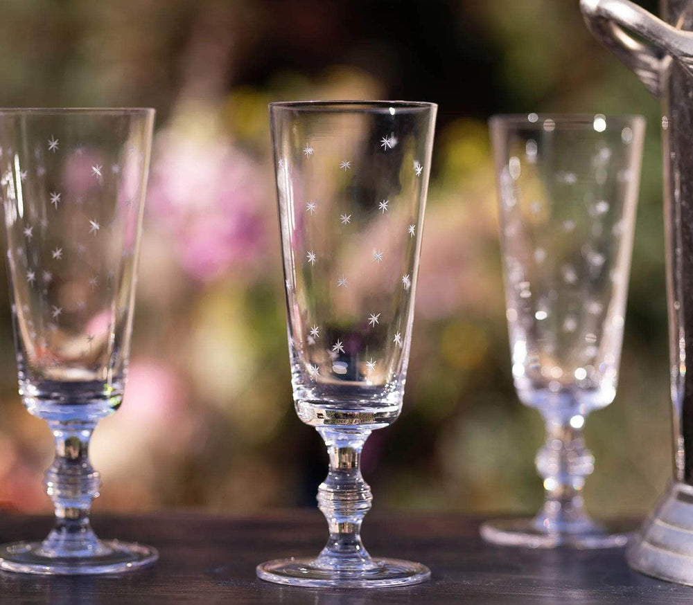 A Set of Four Crystal Champagne Flutes with Stars Design